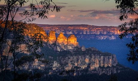 Sweeping view of the Three Sisters rock formations at twilight, in Blue Mountains National Park. Photo &copy; Sydney Scenic Private Tours