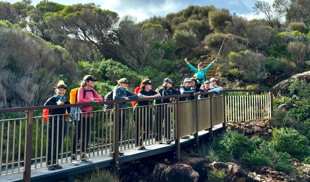 A group of women in hiking gear standing on a bridge in Tomaree Nation Park. Photo: Sharon Mackay &copy; Women Embrace Adventure