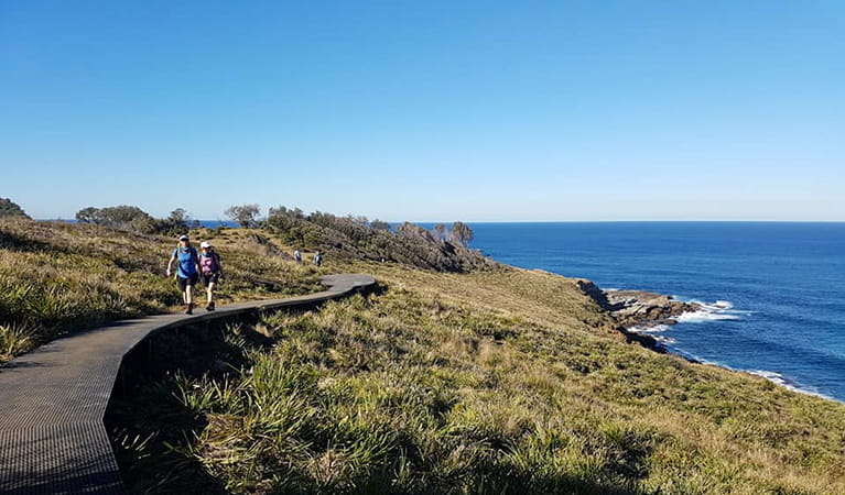 2 women walking The Coast track in Royal National Park with the ocean in the background. Photo: &copy; Women’s Fitness Adventures