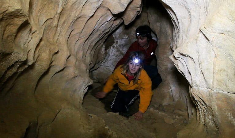 Climbing through a passage in Grove Cave, Abercrombie Caves, Abercrombie Karst Conservation Reserve. Photo: Stephen Babka/OEH