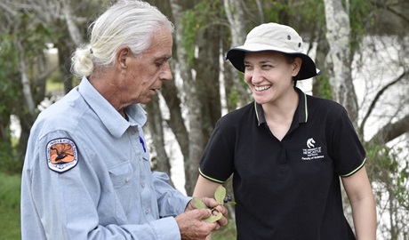 An Aboriginal guide talks with a young person during a NSW National Parks' Aboriginal cultural tour. Photo: Adam Hollingworth/DCCEEW &copy; DPE