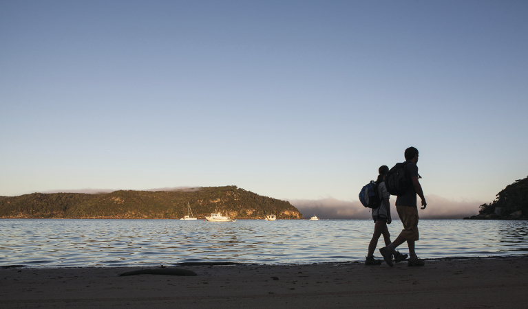 2 people walking towards Barrnejoey Headland in Ku-ring-gai Chase National Park. Photo: D Finnegan/DPIE