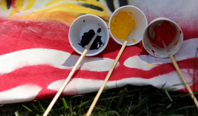 Cups of paint on fabric. Photo: Dylan Jones &copy; DPIE