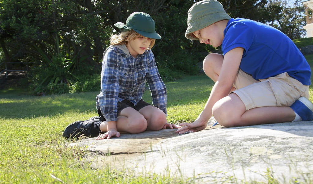 Two kids take part in a nature play activity. Photo: Rosie Nicolai &copy; OEH