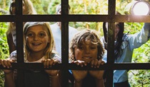 Kids looking through a grate with a torch at Mountain Maid Gold Mine on a Discovery tour. Photo credit and copyright: Destination NSW