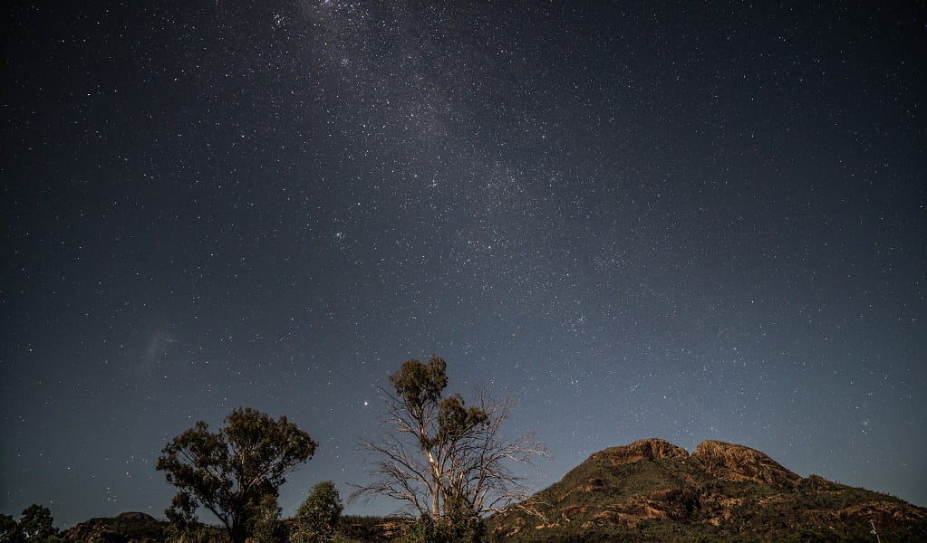 The starry night sky over distant mountain tops in Warrumbungle National Park. Photo: Rob Mulally © Rob Mulally