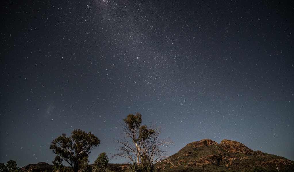 The starry night sky over distant mountain tops in Warrumbungle National Park. Photo: Rob Mulally © the photographer