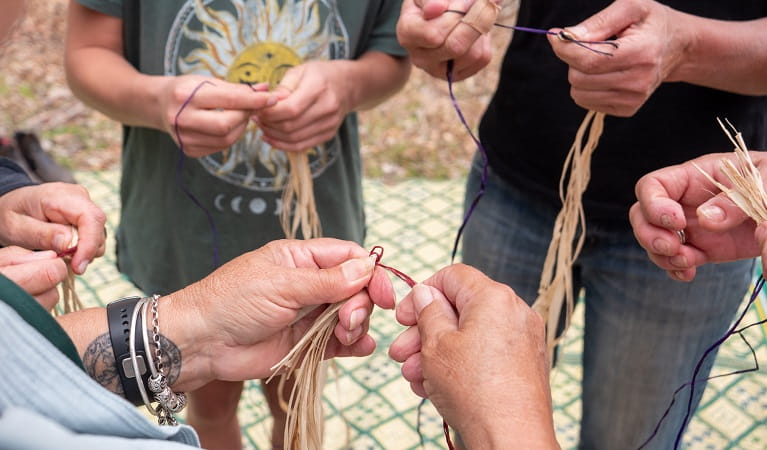 Group being shown the weaving process, Mimosa Rocks National Park. Photo: Jessica Bray &copy; the photographer