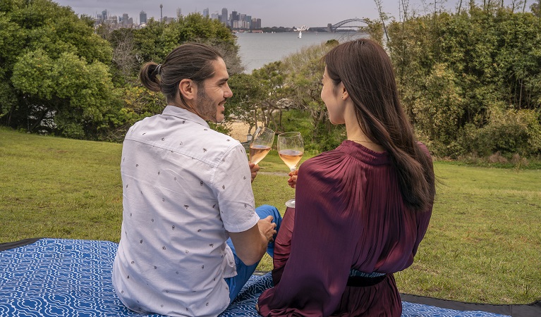 A couple enjoy a picnic on the Strickland Estate lawn, Sydney Harbour National Park. Photo: John Spencer/OEH