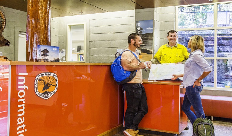 NPWS ranger having a conversation with visitors, Royal National Park Visitor Centre. Photo: Simone Cottrell © DPE