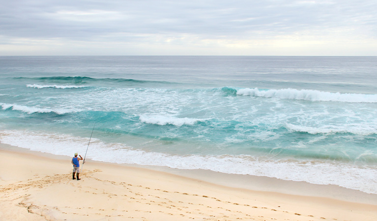 Person fishing at North Quondola Point, Ben Boyd National Park. Photo: John Yurasek