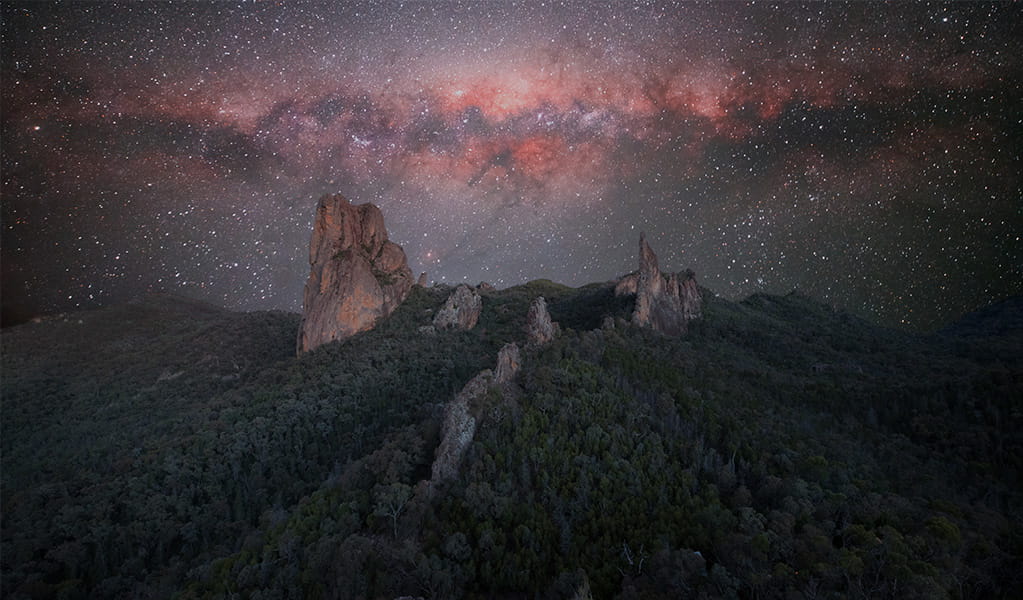 Starry night sky over ‘the breadknife’ rock formation in Warrumbungle National Park. Credit: Ben Heaton/DPE