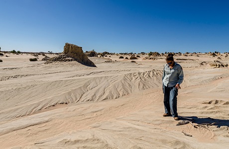 Aboriginal Discovery ranger in front of the Walls of China, Munga National Park. Photo: John Spencer