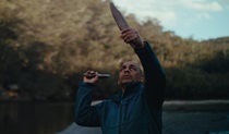 Uncle Dean Kelly using traditional methods during a ceremony to connect to Country by the river near Bobbin Head. Credit: Elise McCarthy &Copy; DPE