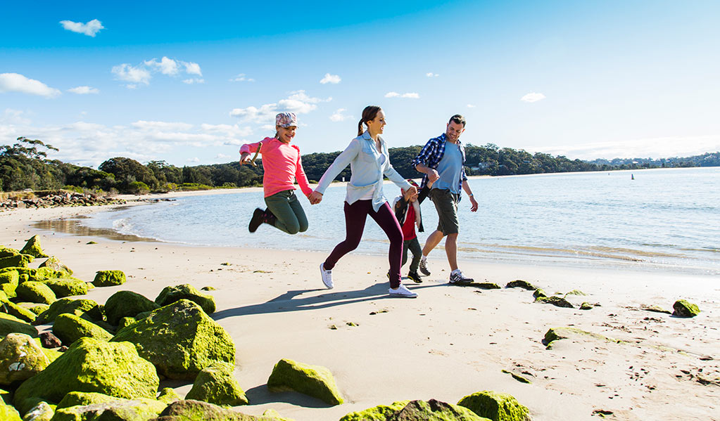 Family walking along the beach near Bonnie Vale picnic area in Royal National Park. Photo: Simone Cottrell/DPIE