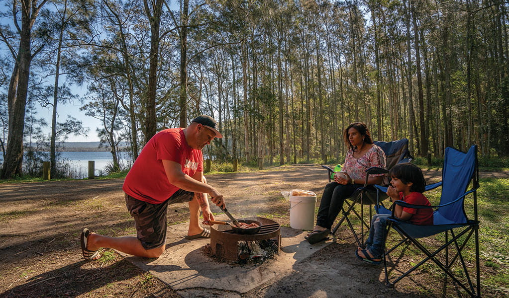 Family cooking  food at Bungaree Bay campground in Myall Lakes National Park. Photo: John Spencer/DPIE