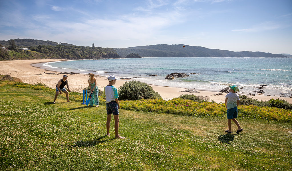 A family playing cricket on Boat Beach, Myall Lakes National Park. Credit: Brent Mail &copy; DPIE