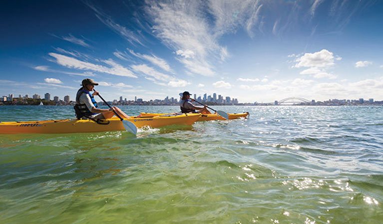 People wearing sunhats, sun protection, paddling their kayaks off Bradleys Head. Photo: David Finnegan/DPIE