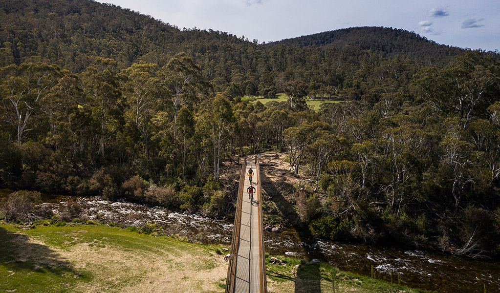 Aerial view of bridge along Thredbo Valley track crossing Thredbo River to Gaden Trout Hatchery, Kosciuszko National Park. Photo: Robert Mulally/DPIE