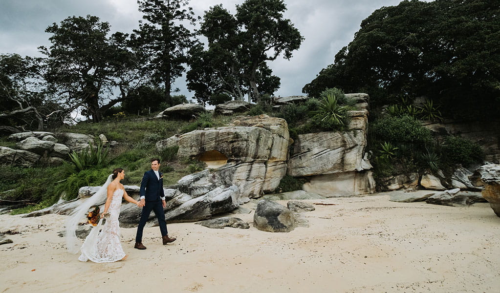 A couple being photographed after exchanging wedding vows in Sydney Harbour National Park. Photo: Matthew Horspool &copy; DPIE
