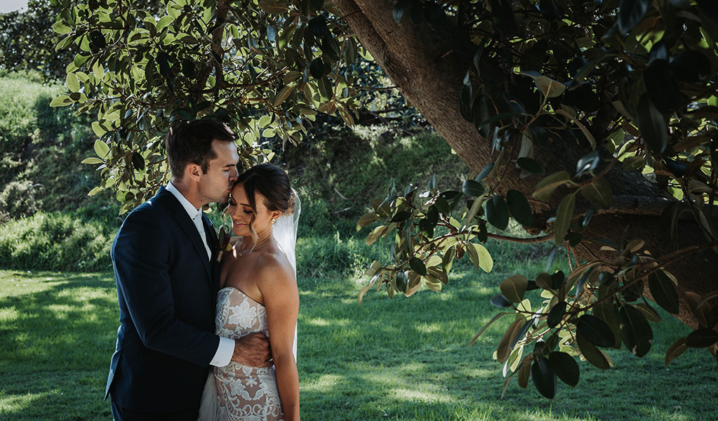 A couple pictured amongst the lush green surrounds at Sydney Harbour National Park. Photo: Matthew Horspool &copy; DPIE