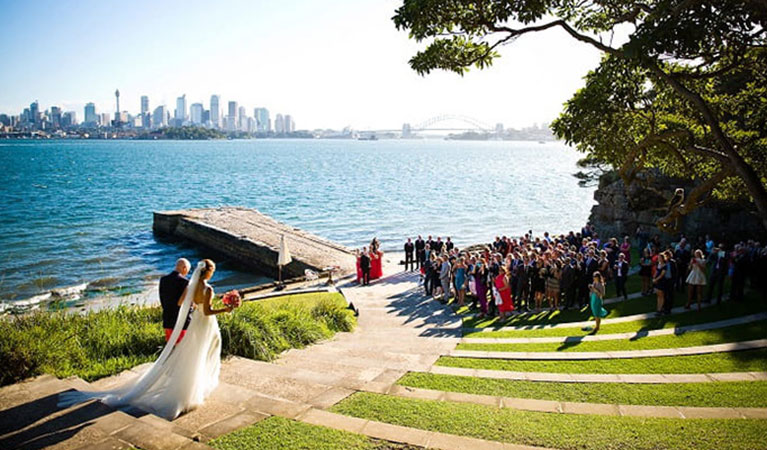 A couple walking down the path towards the water at Bradleys Head Amphitheatre in Sydney Harbour National Park. Photo: &copy; McKay Photography