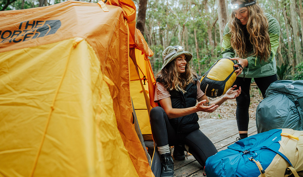Campers setting up their tent at Depot Beach campground. Credit: Remy Brand/DCCEEW © Remy Brand
