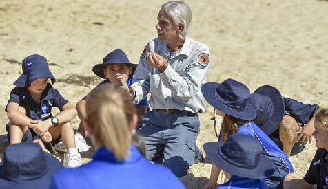Aboriginal ranger Uncle Gary with junior students on the beach, Glenrock State Conservation Area, 2019. Photo: Adam Hollingworth: Hired Gun &copy; DPIE