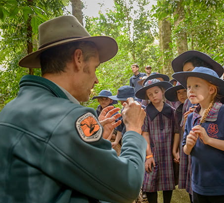 School children talking to a ranger at Dorrigo National Park. Photo: John Spencer &copy; DPE