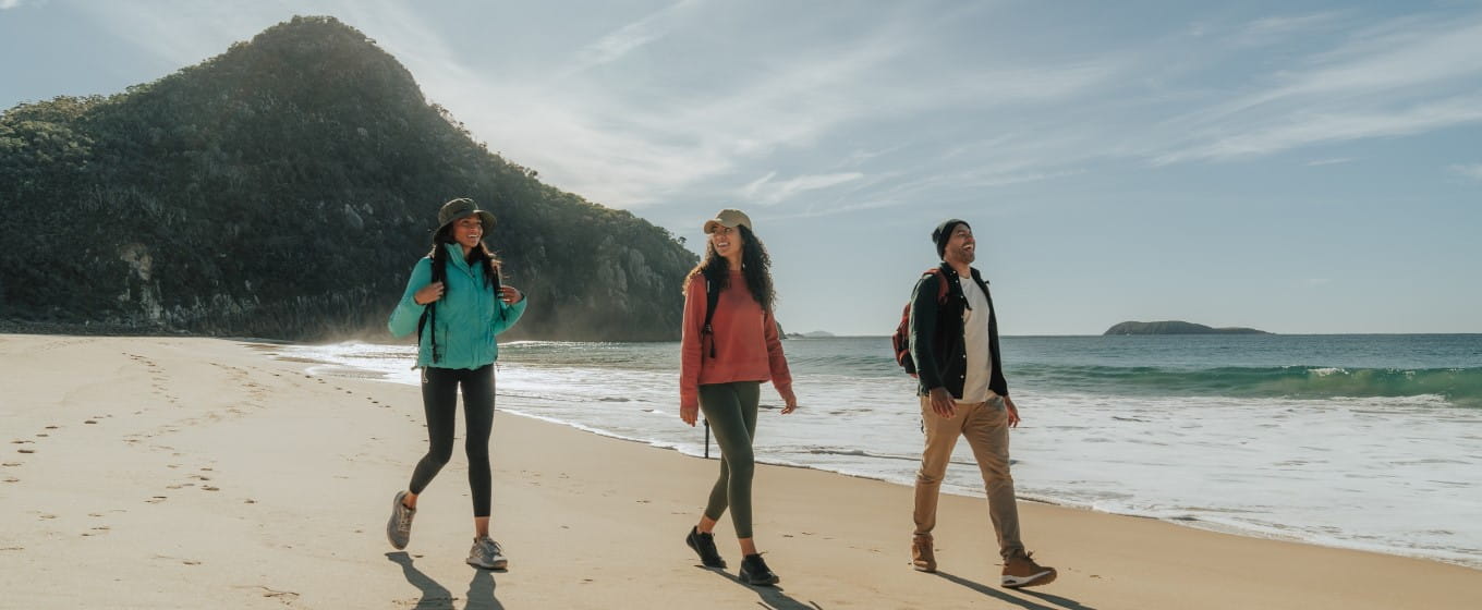 Three people walking on Zenith Beach in Tomaree National Park. Credit: Remy Brand &copy; Remy Brand