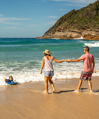 Family at the beach, The Ruins campground, Booti Booti National Park. Credit: John Spencer &copy; DPE