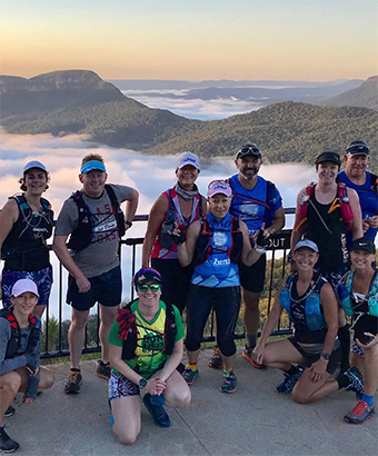 A group of runners in front of a sweeping view of mountains and valleys. Photo: Tony Williams &copy; Blue Mountains Fitness