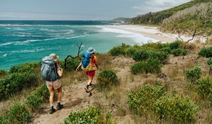 2 bushwalkers on Murramarang South Coast Walk between Pretty Beach and Pebbly Beach. Credit: Remy Brand © Remy Brand