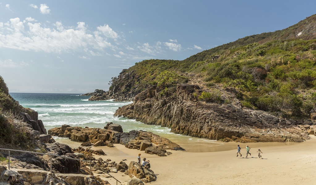 Family running along Little Bay beach, Arakoon National Park. Photo: David Finnegan/DPE