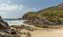 Family running along Little Bay beach, Arakoon National Park. Photo: David Finnegan/DPE