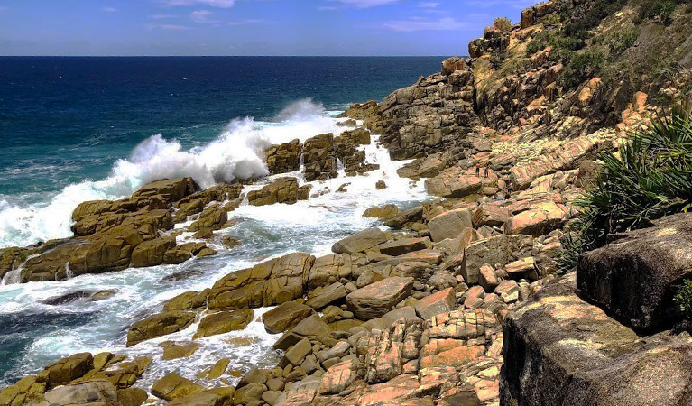 Large swell crashing over rocks and into Mermaid Pools in Arakoon National Park. Image credit: Shane Robinson &copy; DPIE