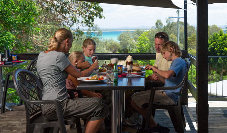 A family enjoying a meal at Trial Bay Kiosk Restaurant, Arakoon National Park. Photo: David Finnegan/NSW Government