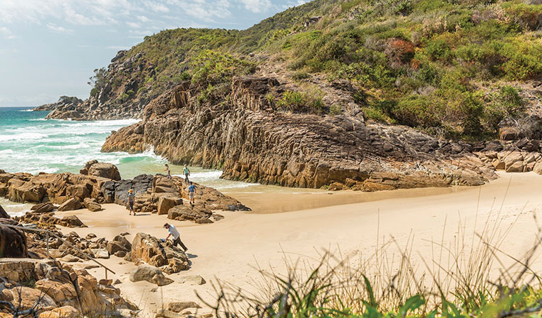 A family exploring the rocks at Little Bay beach in Arakoon National Park. Photo: David Finnegan/DPIE