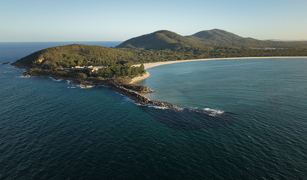 Aerial view of the headland and ocean at Trial Bay in Arakoon National Park. Credit: Glen Ellis &copy; DCCEEW