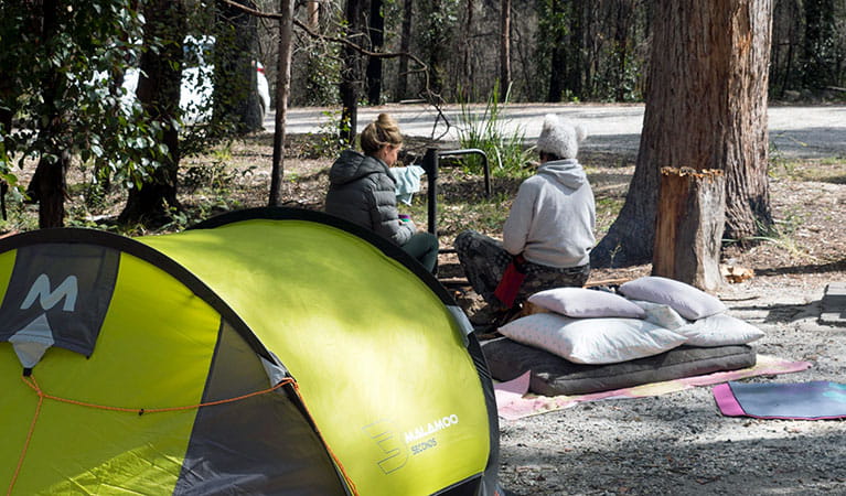 2 campers beside their tent at Bald Rock campground and picnic area in Bald Rock National Park. Photo: Leah Pippos &copy; DPIE