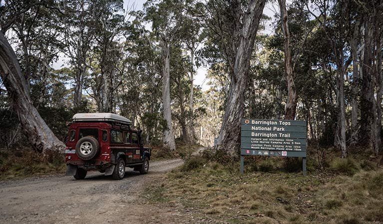 A 4WD vehicle drives past a sign on Barrington trail, Barrington National Park. Photo: Robert Mulally/OEH.