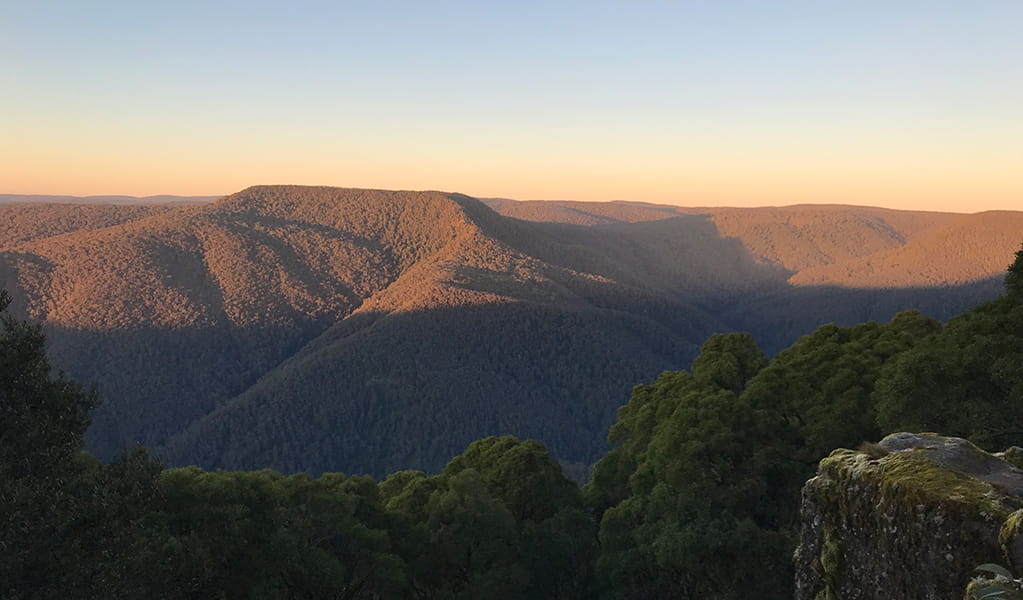 Sunset casting shadows over the mountains in view from Careys Peak lookout in Barrington Tops National Park. Credit: Richard Bjork &copy; DPE