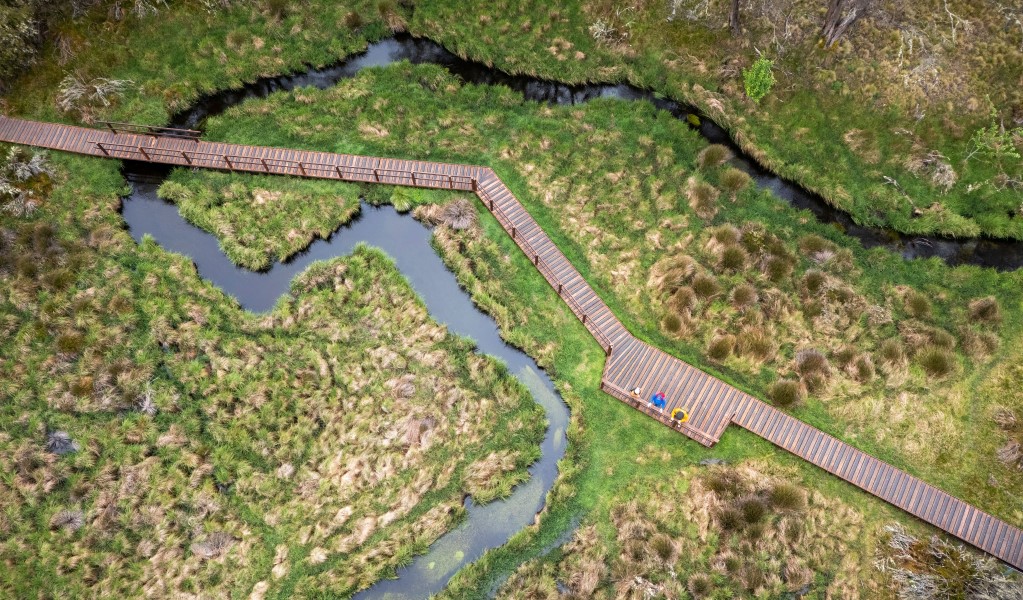 An aerial view of people on the raised wooden walkway of Polblue Swamp track in Barrington Tops National Park. Photo: John Spencer &copy; DCCEEW