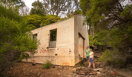 A couple inspecting the historic ruins at Bittangabee Bay. Photo: John Spencer/OEH