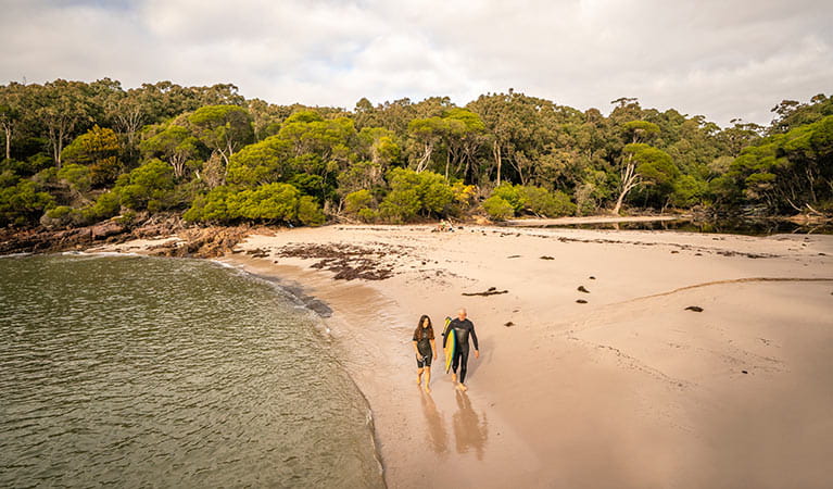 People walking along the sand at Bittangabee Bay. Photo: John Spencer/OEH