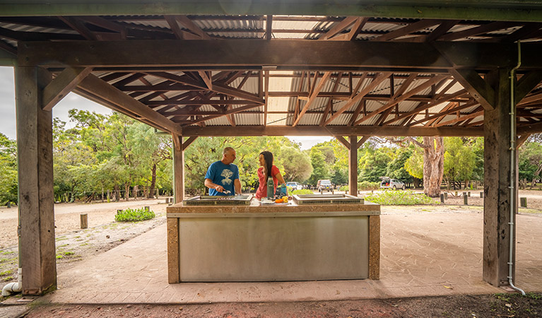 People using barbecue at a shelter at Bittangabee campground, Beowa National Park. Photo: John Spencer/OEH