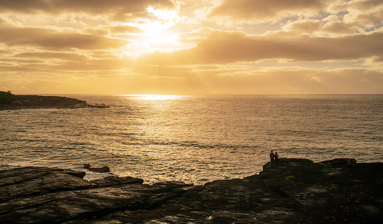 Walkers on the coastal cliffs near Bittangabee campground, Beowa National Park. Photo: John Spencer/OEH