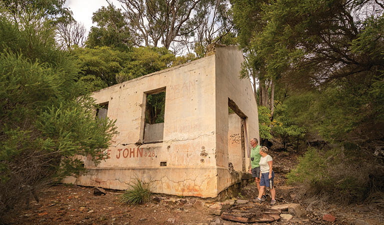 Visitors a the Bittangabee Bay ruins. Photo: John Spencer/DPIE