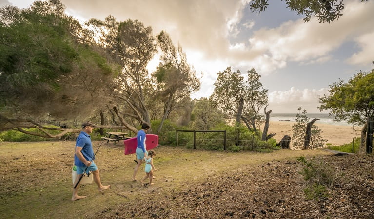 A family heads to the beach at Haycock Point picnic area, Beowa National Park. Photo: John Spencer/OEH
