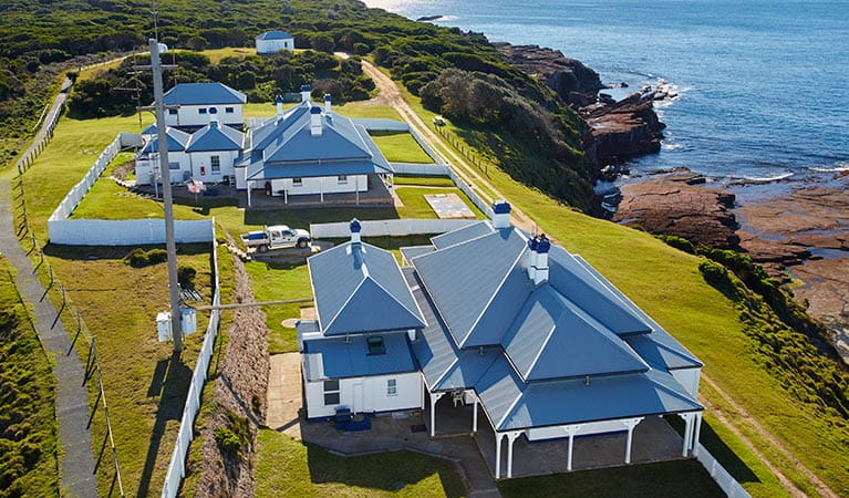 Aerial view of Green Cape Lightstation Keepers Cottages, next to the ocean. Photo: N Cubbin/DPIE